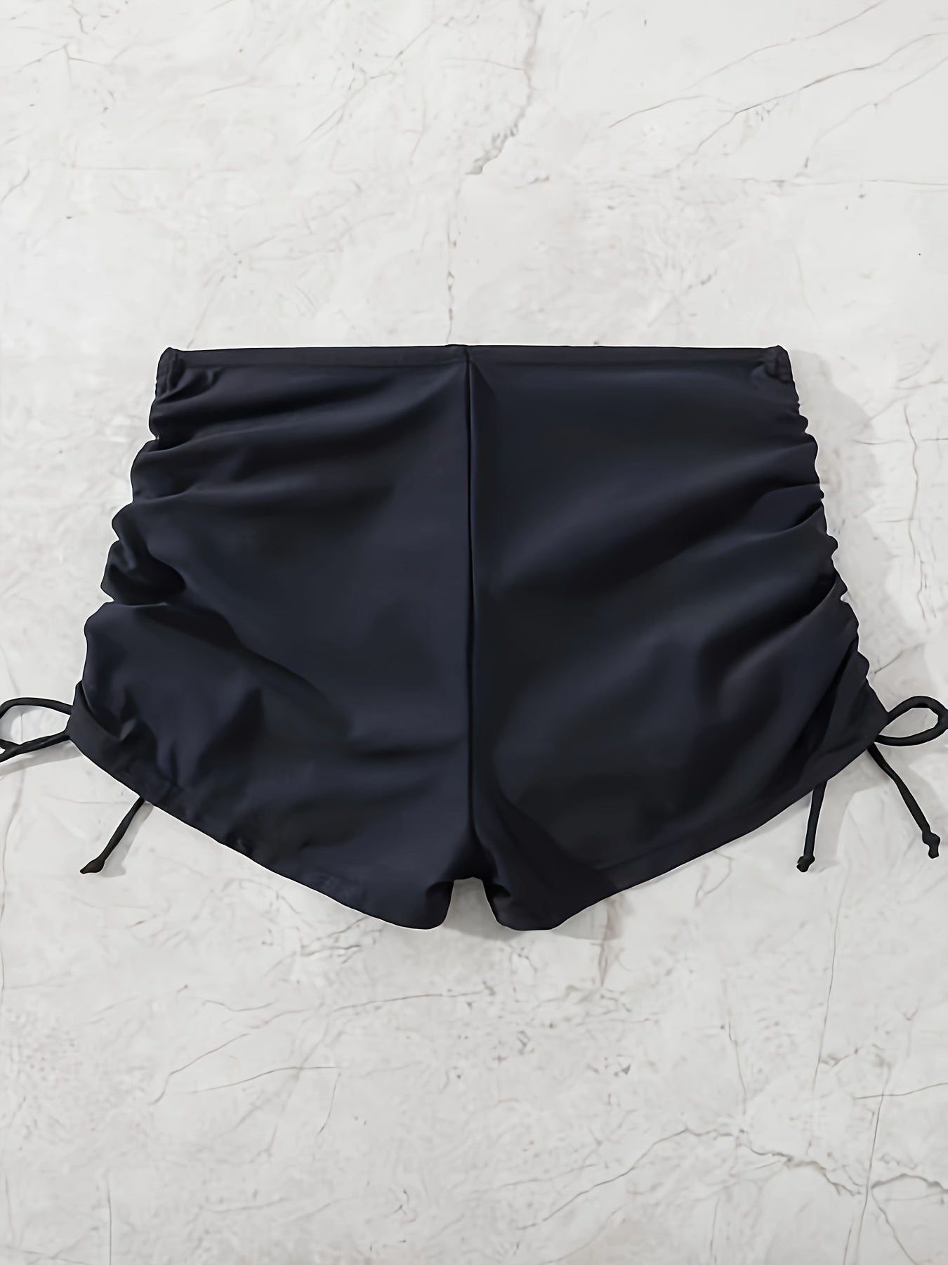 Black drawstring swim shorts for women.