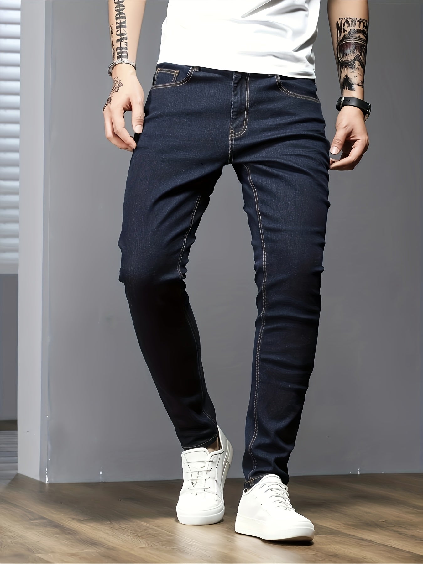 Men's slim fit jeans in solid color, made with stretch denim fabric and raw wash detail, suitable for all seasons.