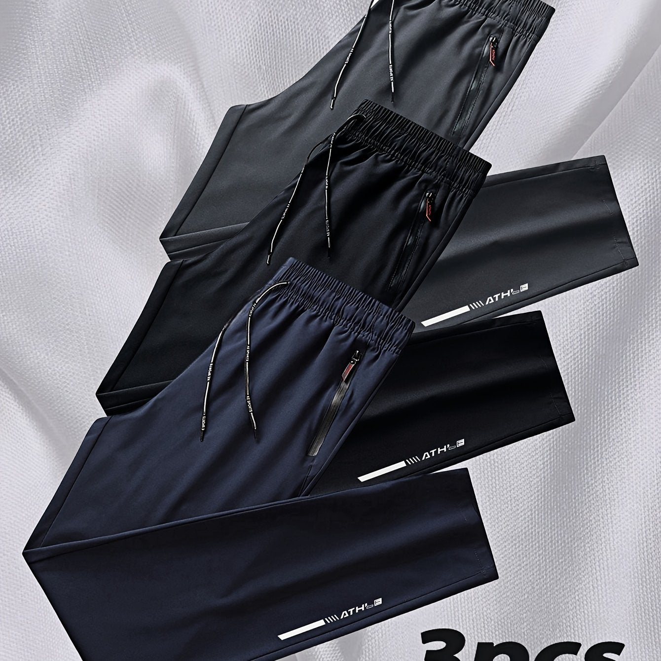 Men's 3-pack casual running pants made from 100% polyester non-stretch woven fabric. Features regular fit with zipper details, print pattern, and summer breathable quick-dry design.