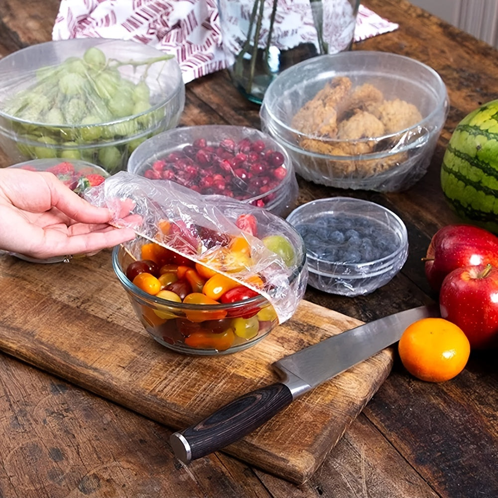 50-100 pieces of disposable fresh-keeping covers made of plastic for use in storing food. These covers are elastic and can be used to cover various storage containers in the kitchen or outdoors during picnics and camping trips.