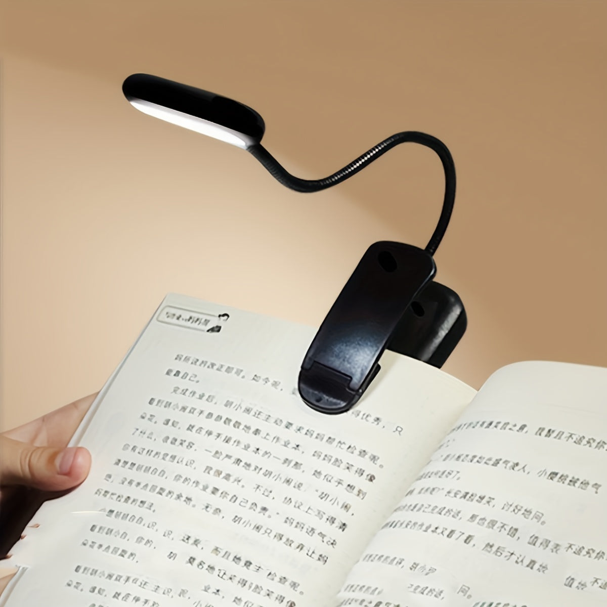 Portable battery-powered clip-on book light with a flexible hose, ideal for reading in small spaces or as a bedside night light.