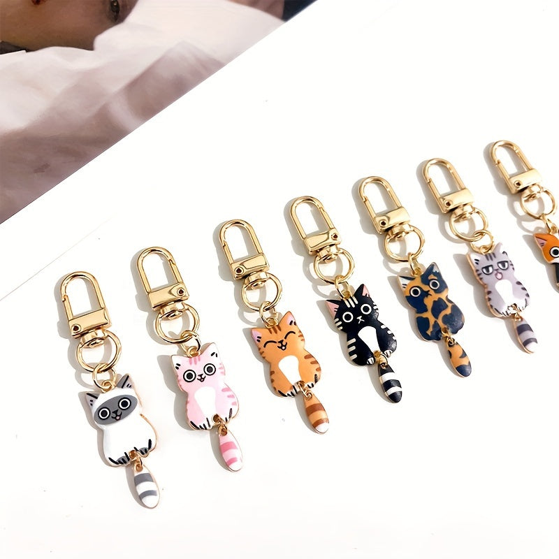 A collection of 7 adorable cat tail keychains made with zinc alloy featuring movable tails. Perfect as handbag charms and zipper pulls, these kitty keyrings make a fashionable accessory gift.