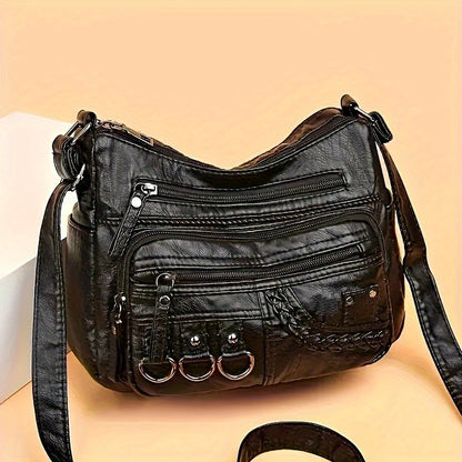 Casual black crossbody bag with multiple zippers for daily use.