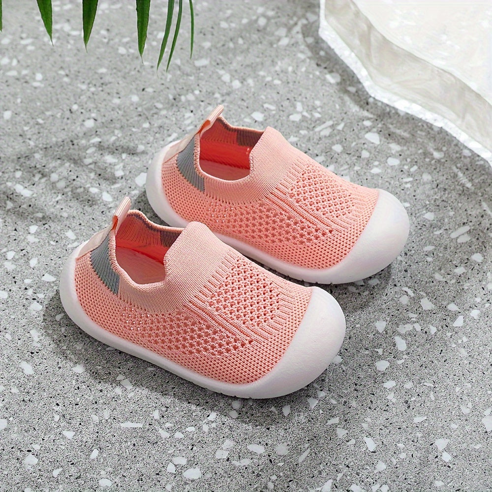 Soft infant walking shoes for toddlers made with knitted fabric.