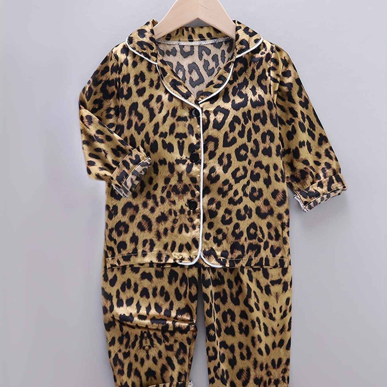 Comfortable leopard print pajamas with front buttons, long sleeves, elastic waistband, and long pants for home wear.