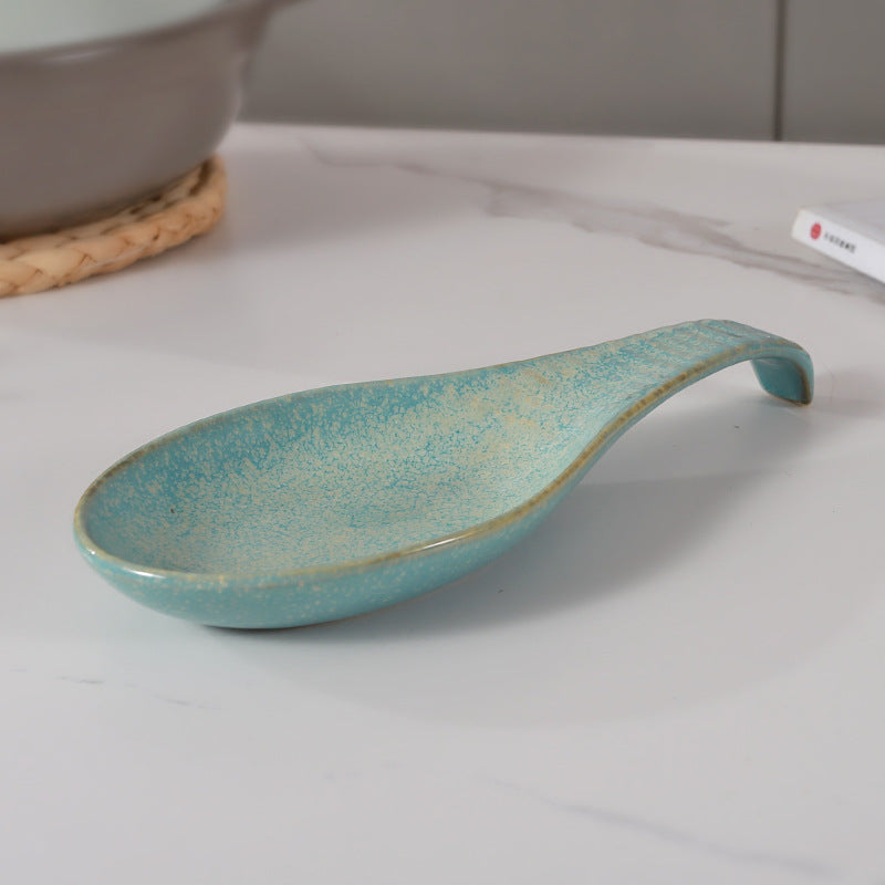 A single piece Ceramic Spoon Rest, beautifully handcrafted Soup Ladle Holder, featuring a Modern Country Style design. Perfect for organizing kitchen utensils, this European Vintage Creative Reaction Glaze piece comes with a practical Ladle Stand for