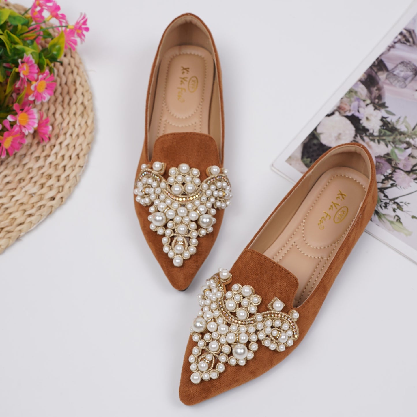 Women's elegant flat shoes with faux pearl decoration, point toe design, and lightweight comfort.