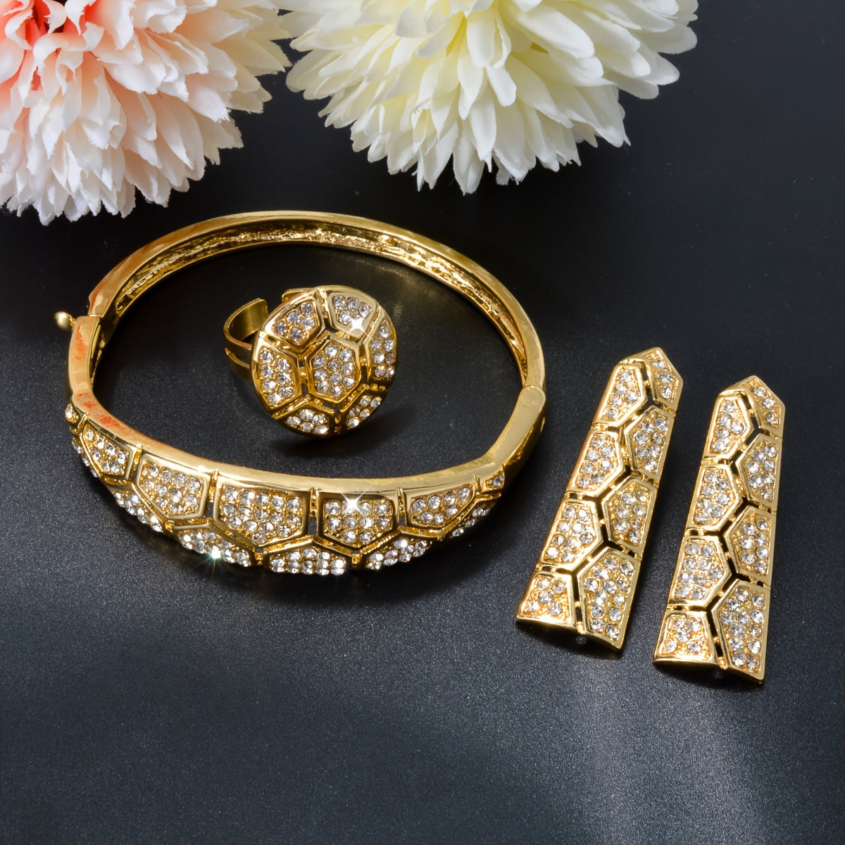 Luxurious and elegant, the ZEADEAR Copper Jewelry Set is adorned with sparkling Zirconia in a beautiful mosaic pattern. This set includes a stunning Geometric Pentagon Necklace, Bracelet, Earrings, and Ring, perfect for weddings and banquets. Inspired by