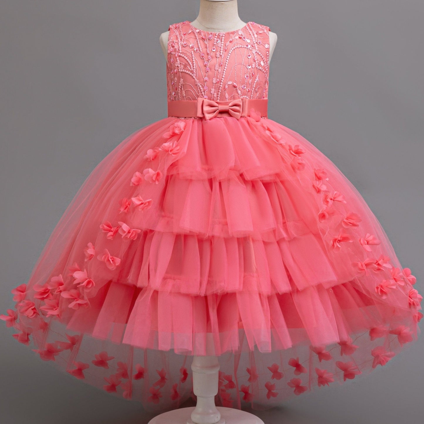 Stylish pink princess dress for girls with floral appliqués, tulle overlay, and bow detail - perfect for pageants, parties, and performances.