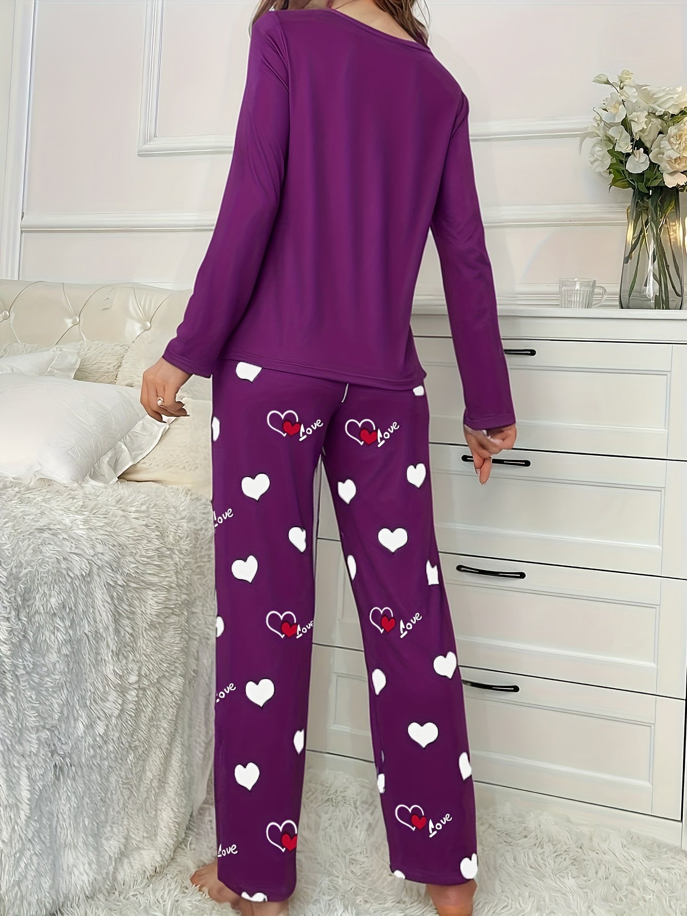 Women's heart print 2-piece pajama set includes long sleeve crew neck top and elastic waist pants in cozy polyester blend for fall/winter.