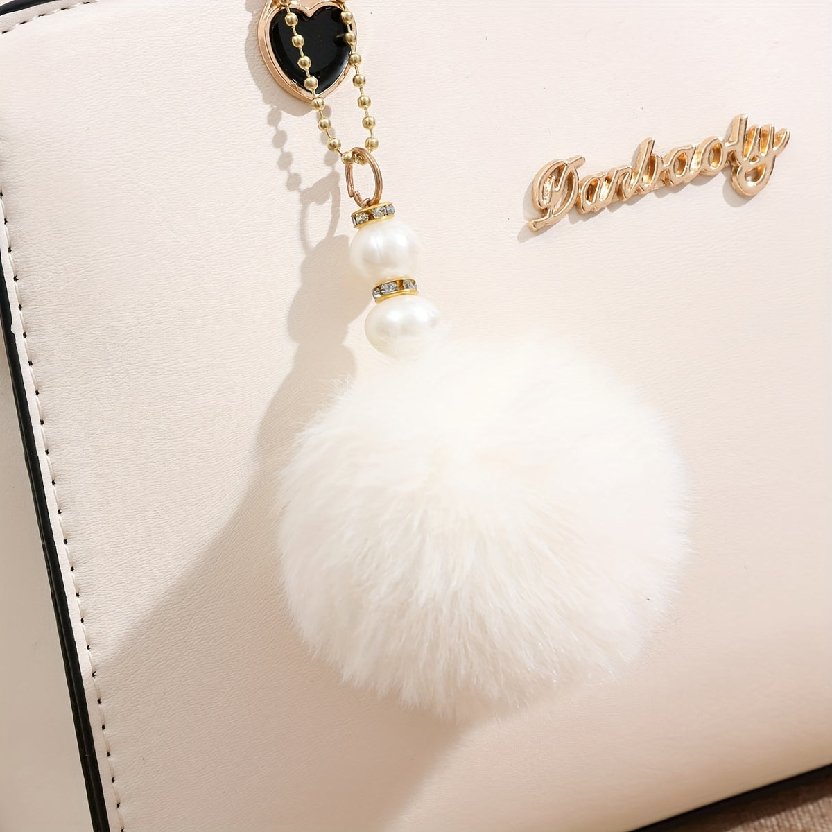 Solid color handbag with multi-layer crossbody design, satchel purse for women with pompom ball charms.