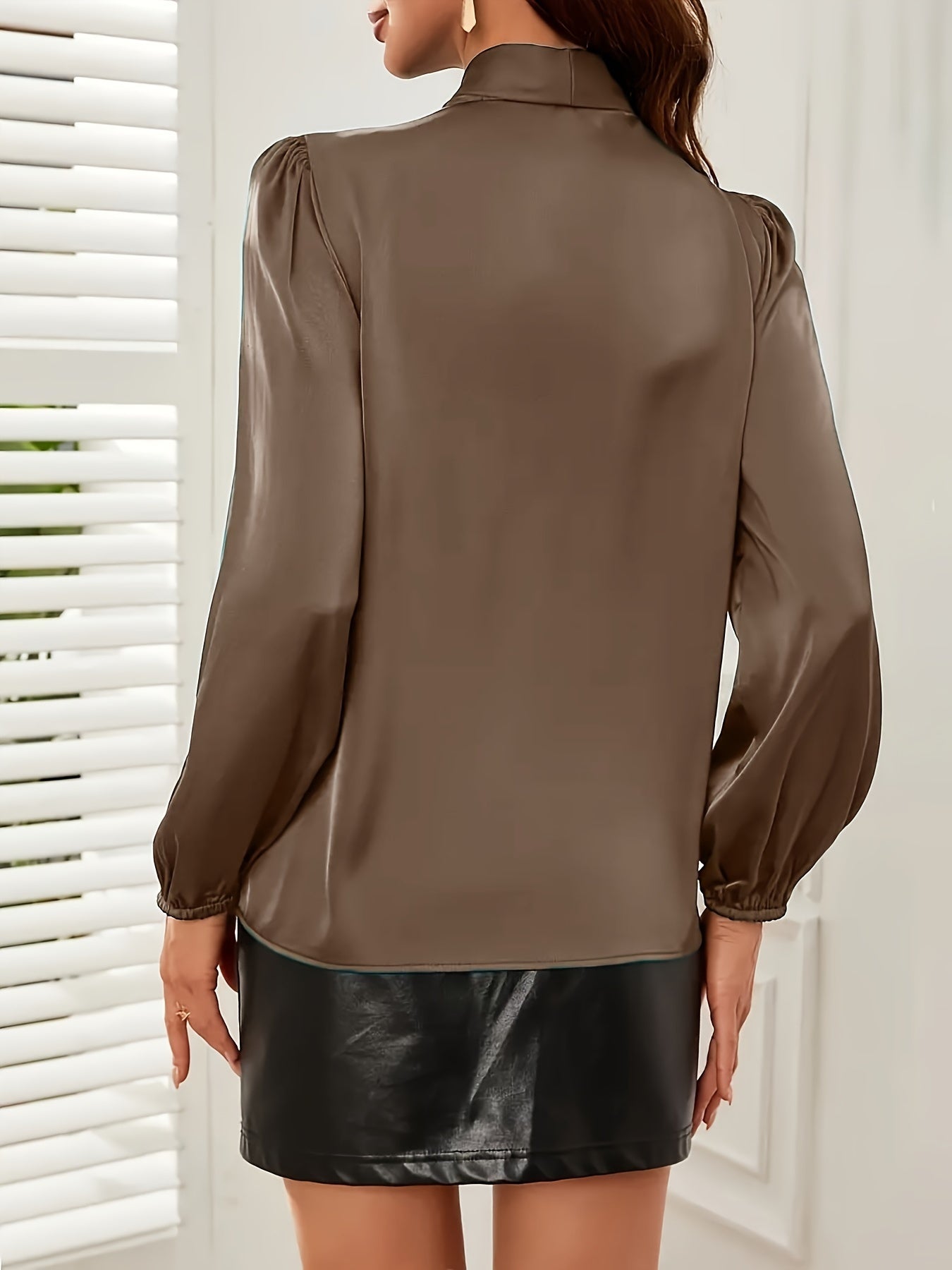 Chic tie-neck blouse with ruffle detail, perfect for work or parties in beige polyester, machine washable.