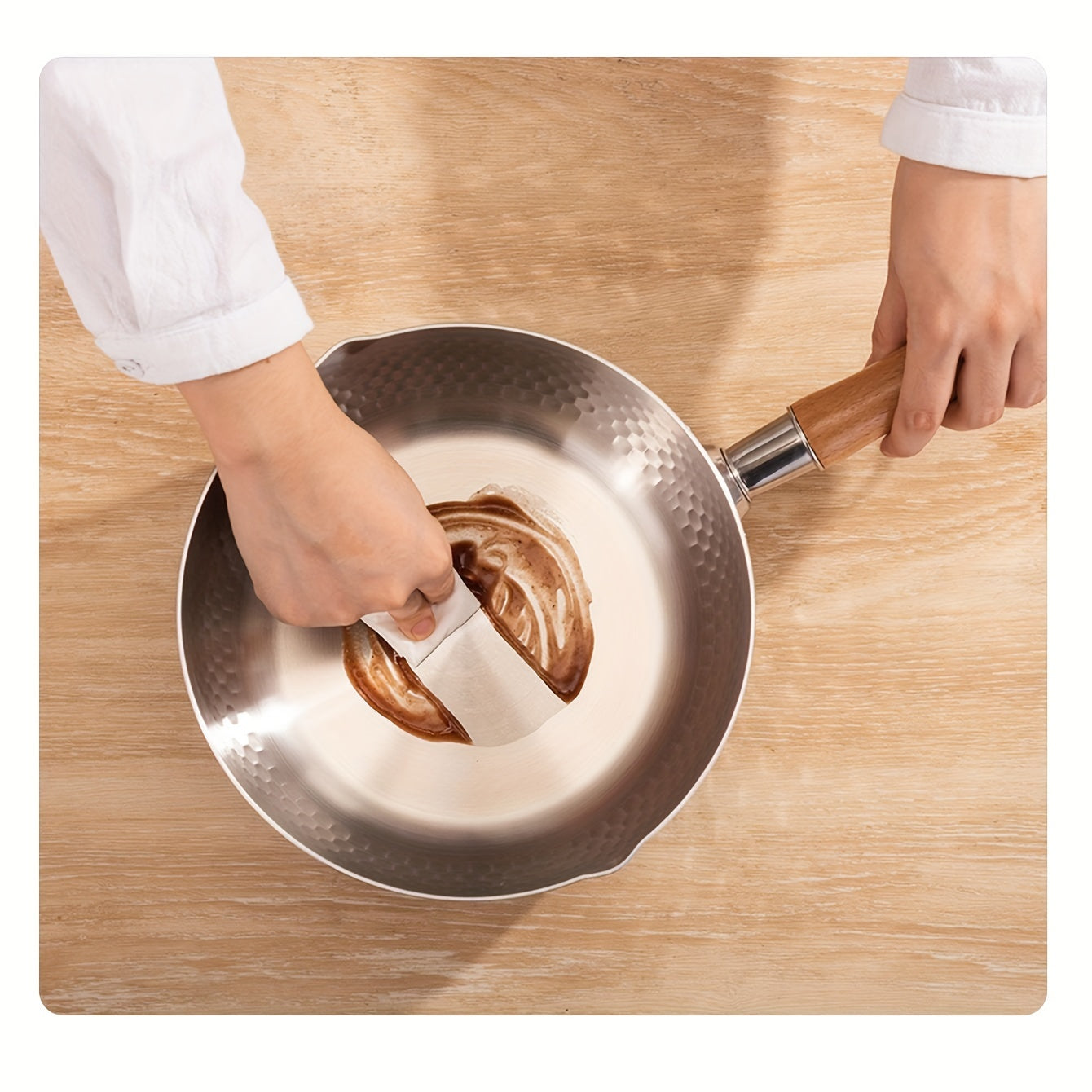 A small soup pot for home use without power supply made of 304 brushed finish stainless steel, featuring a wooden handle and induction compatibility