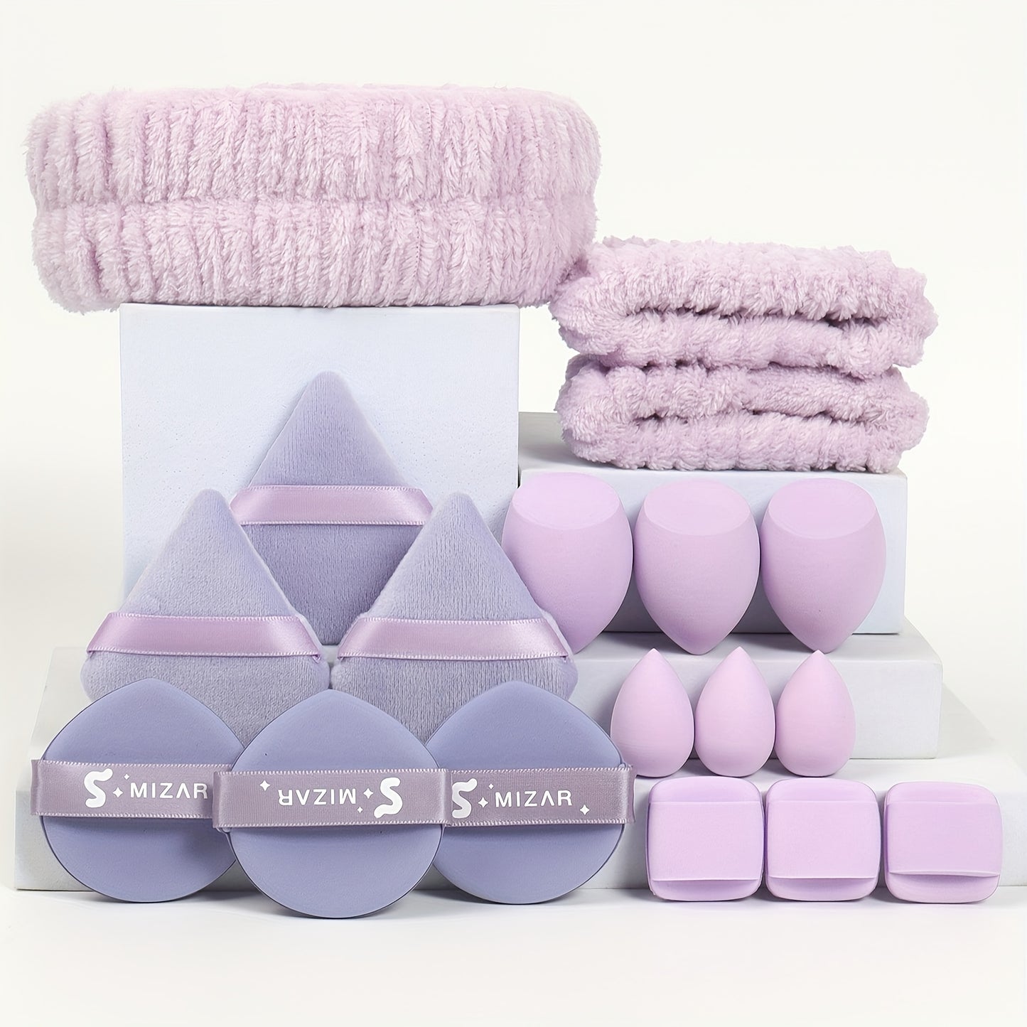 18-piece set including 1 hairband, 2 wristbands, 3 makeup sponges, 3 mini makeup sponges, 3 loose powder puffs, and 6 air cushion puffs. Features foundation mixing sponge for flawless