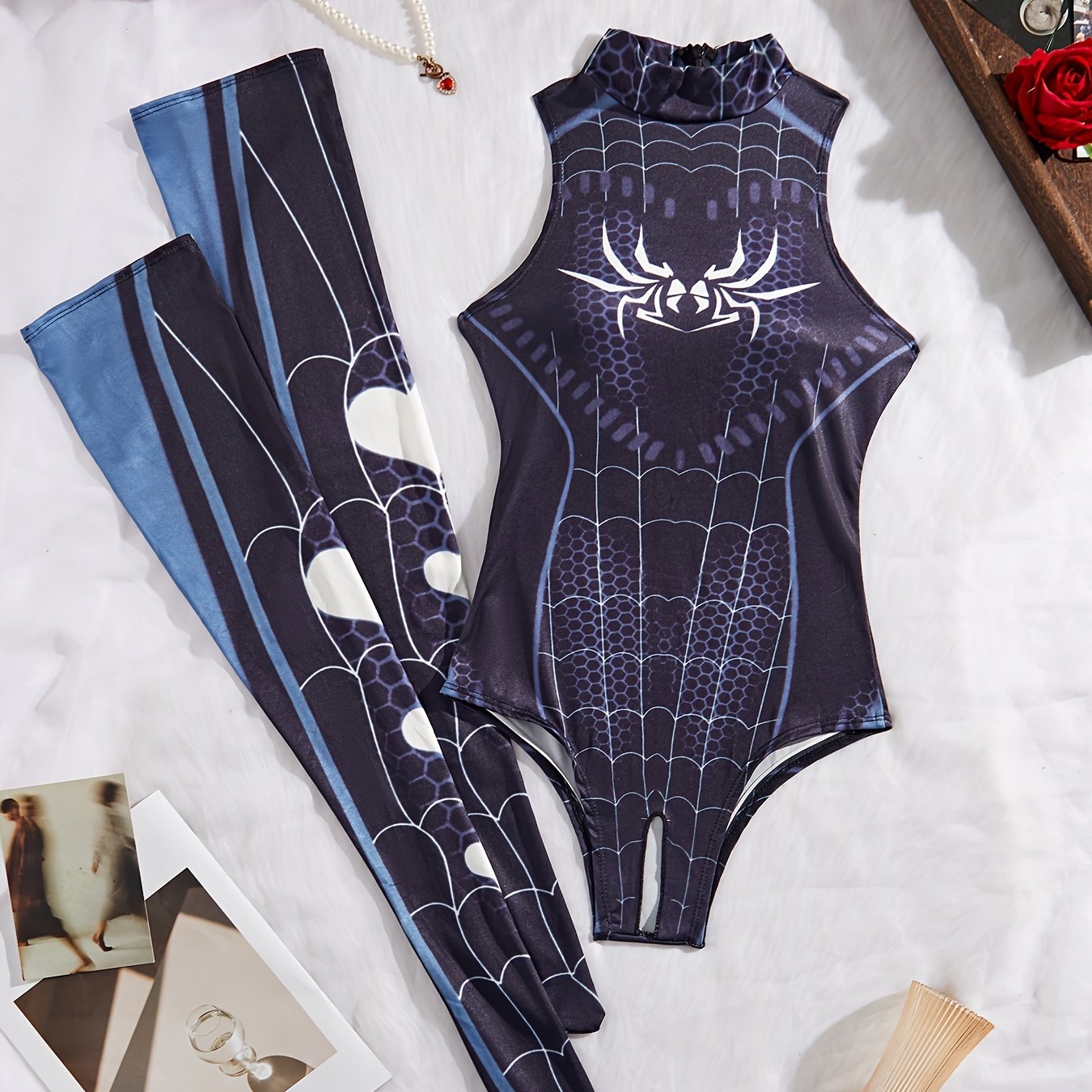 Sexy lingerie set includes spider themed bodysuit, socks, and costume.