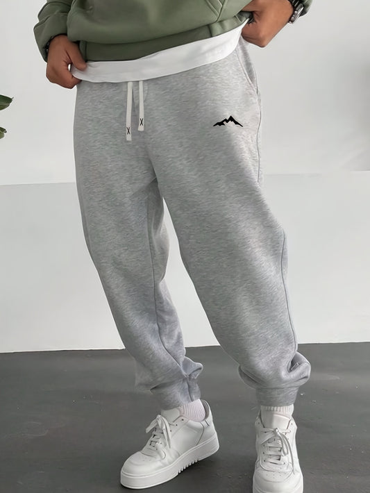 Plus size men's fleece-lined sweatpants with stylish mountain print, drawstring waist, and machine washable polyester for fall/winter. Casual and stylish joggers.