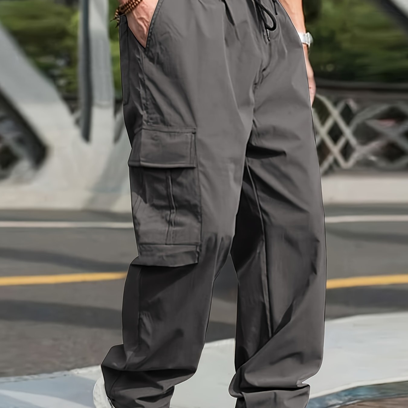 Men's olive green cargo pants with side pockets, adjustable waist, and lightweight twill fabric - perfect for casual street style jogging in all seasons.