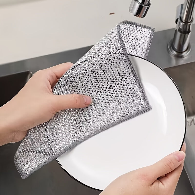 Kitchen scrubbing pads with a double-layer silvery edge are available in packs of 5 or 15. These scratch-resistant cloths can be used wet or dry for cleaning tableware, steel wire, and various surfaces such as bathroom doors and windows. The magic