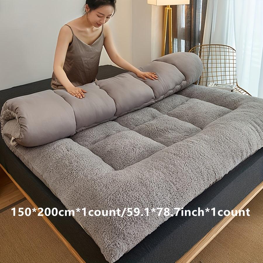 Soft, reversible gray mattress protector with corner straps for easy storage and transport. Ideal for cozy bedrooms.