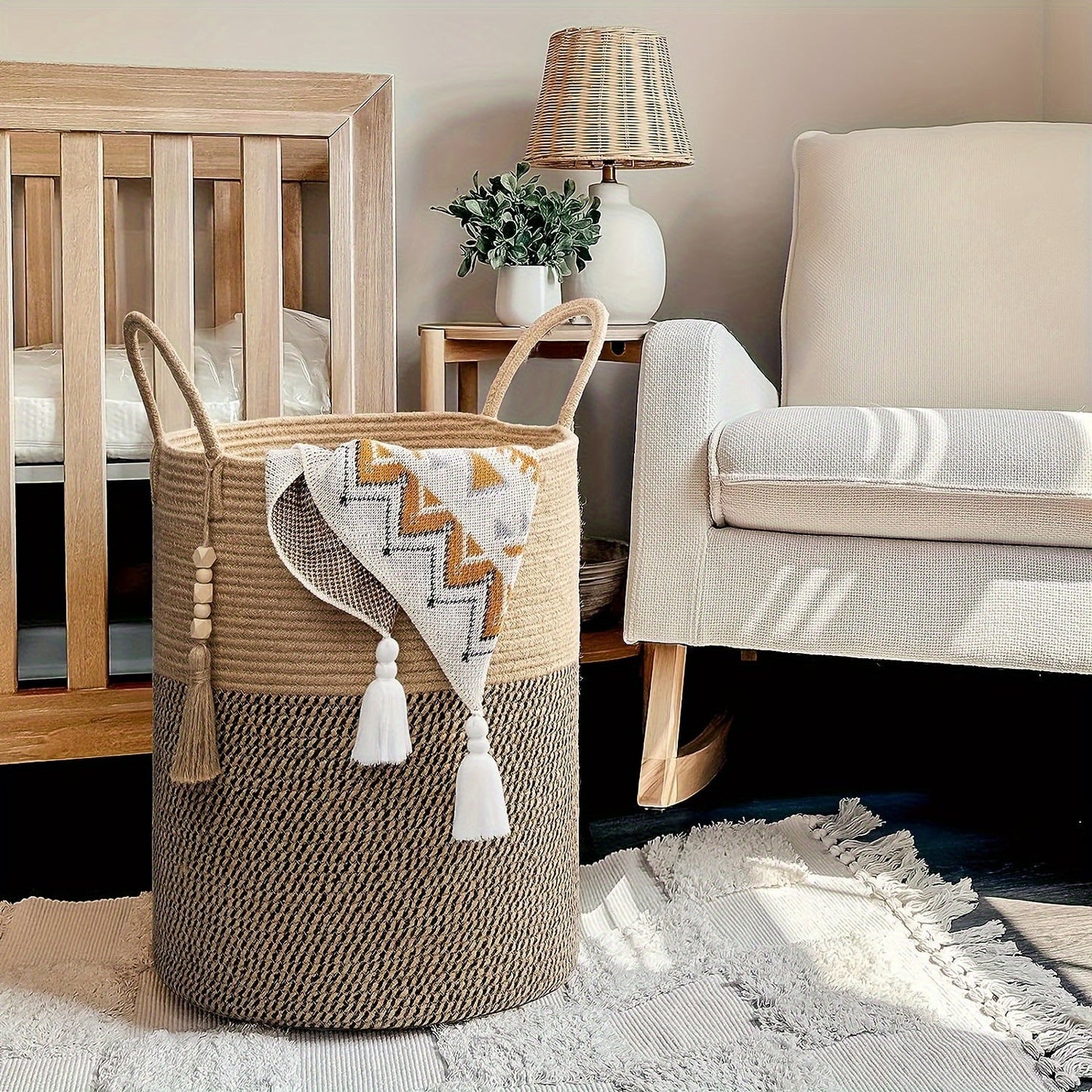 This tall laundry basket measures 40.64cm X 50.8cm and features a woven design with a convenient handle. It can be used as a blanket organizer in the living room, a storage basket for dog toys, or a decorative jute laundry hamper for clothes, pillows