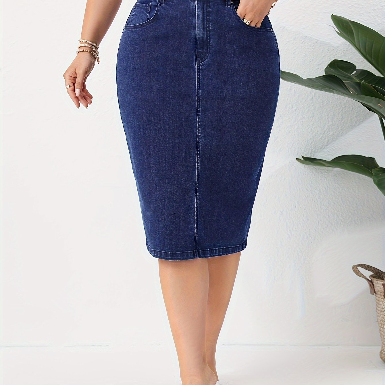 Blue washed high rise plus size bodycon denim skirt with slash pockets for women.