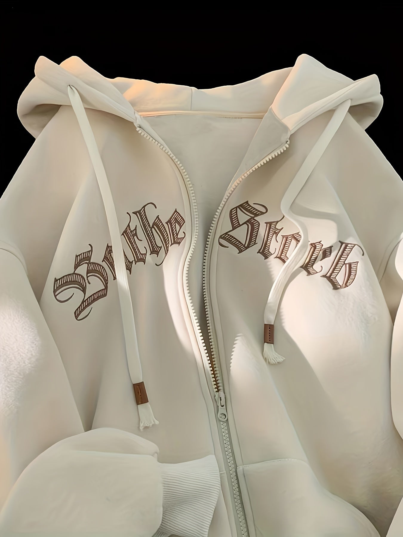 Women's chic zip-up hoodie jacket featuring "THE STRK" embroidery on long sleeves, made of polyester, ideal for spring and fall.