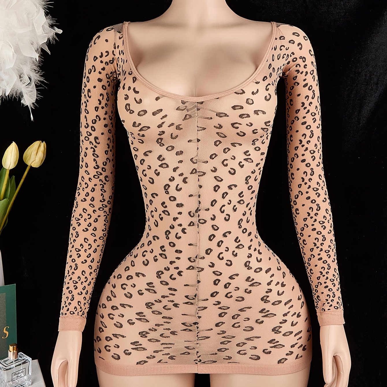 Leopard print bodycon bodysuit with long sleeves, backless design, and no padding. Made of 95% polyamide and 5% elastane. 100gsm lining. Adult size.