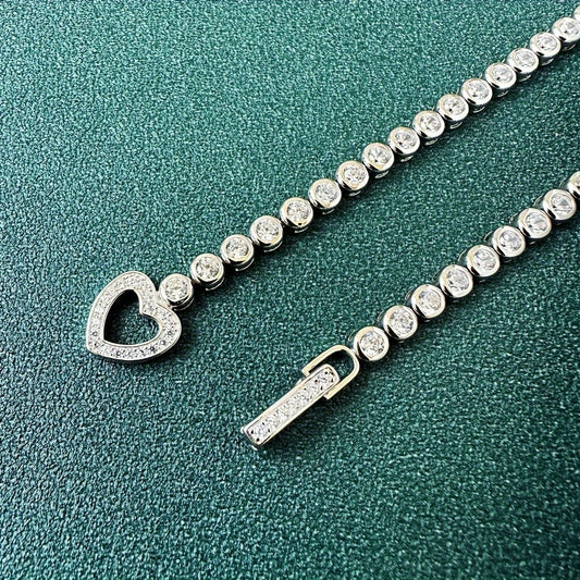 Sterling silver bracelet featuring a heart charm adorned with cubic zirconia, perfect for daily wear or as a gift. Designed with a nautical theme and featuring a September birthstone.