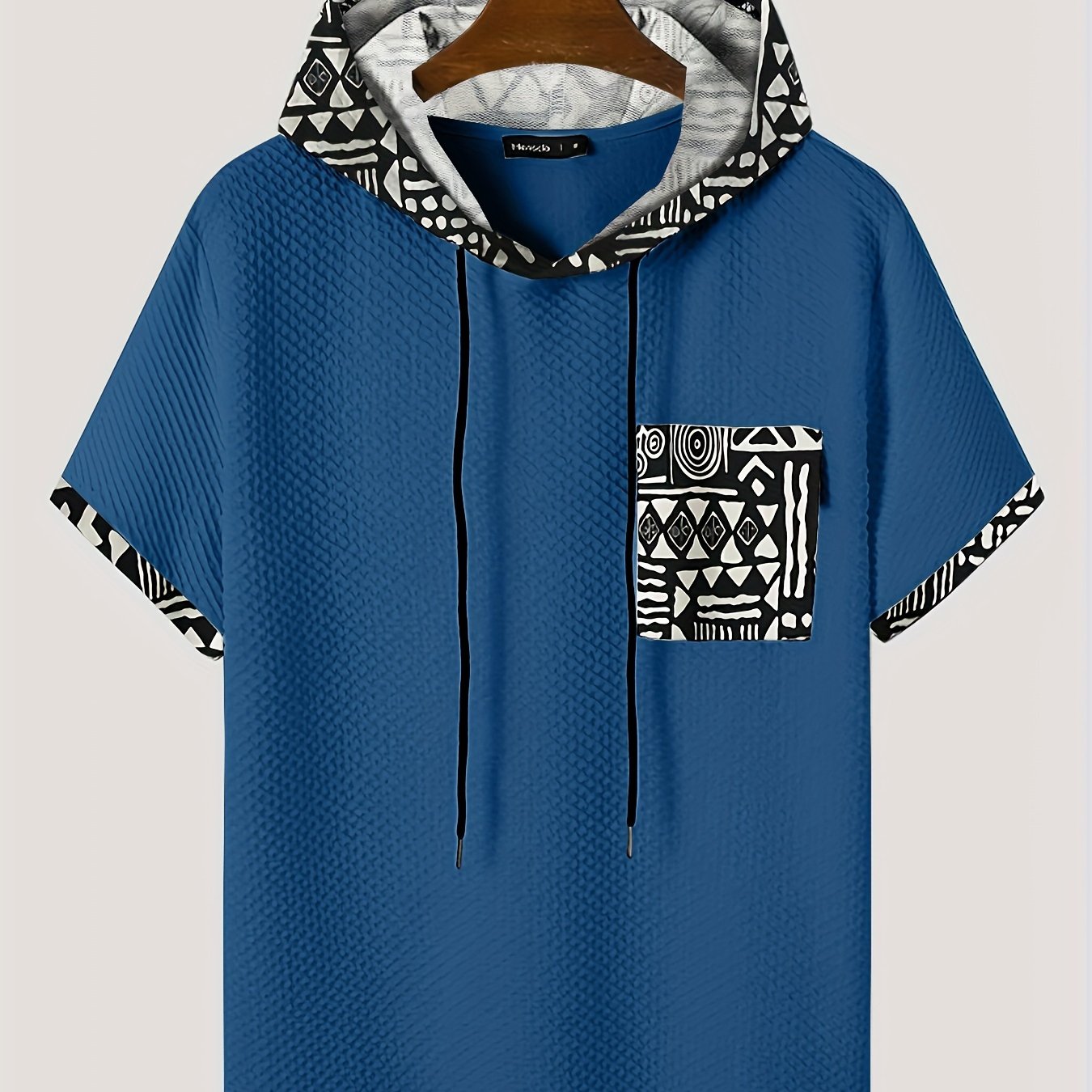 Men's plus size casual hooded t-shirt with geometric print, made from lightweight polyester fabric in gray with black and white patterns. Includes drawstring hood for comfortable fit and