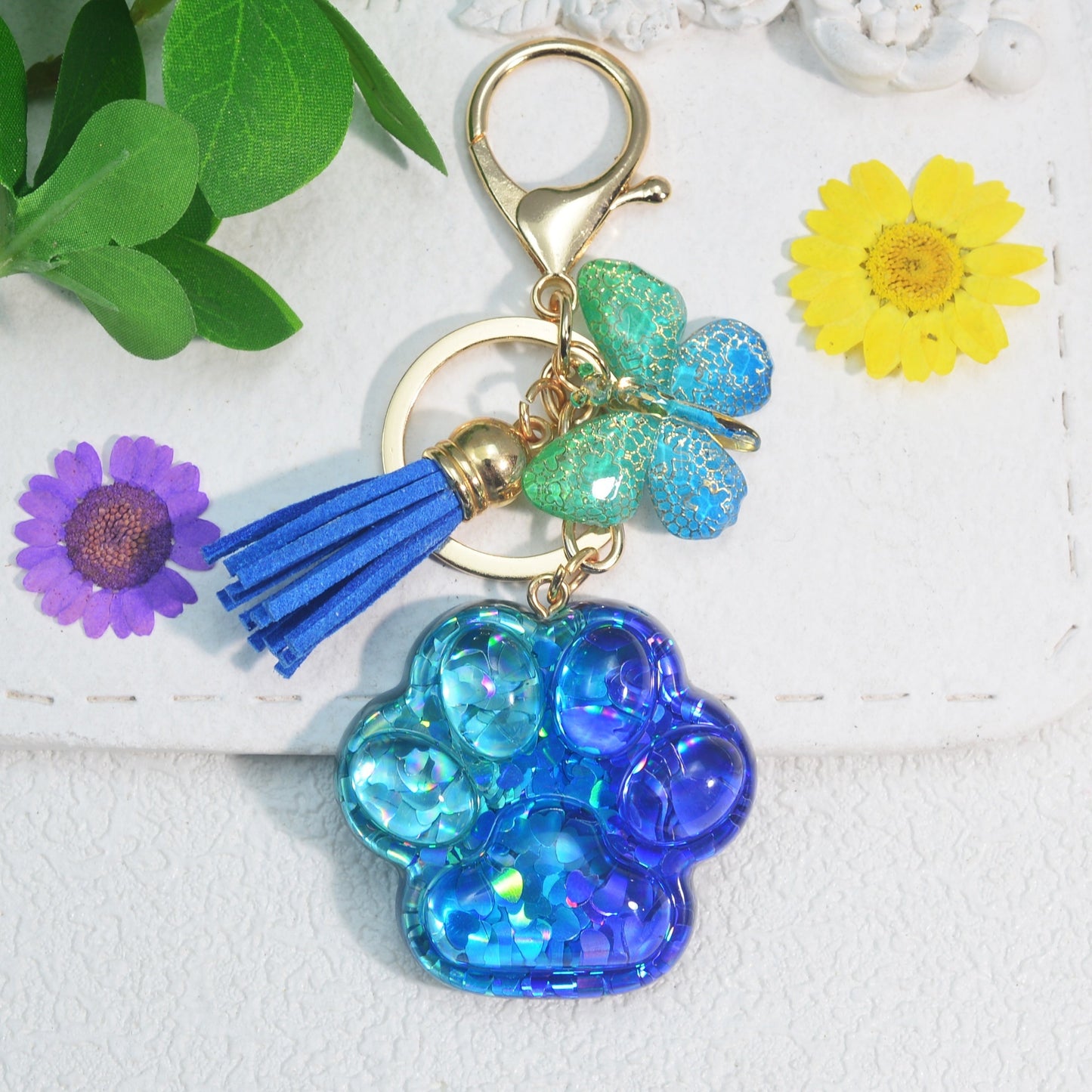 Butterfly tassel ladies bag keychain pendant in the shape of a cat's paw, perfect as a birthday or holiday gift for a creative animal lover.