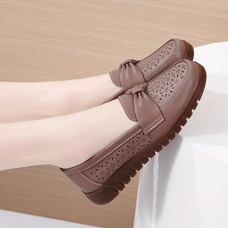 Flat loafers for women with hollow out design, bow detail, soft sole, suitable for casual walking.