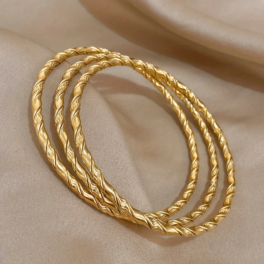 Set of 3 Golden Twist Stainless Steel Bangles, featuring a Chic Classic Tibetan Buddha design. Can be stacked for a stylish look, perfect for both women and men.