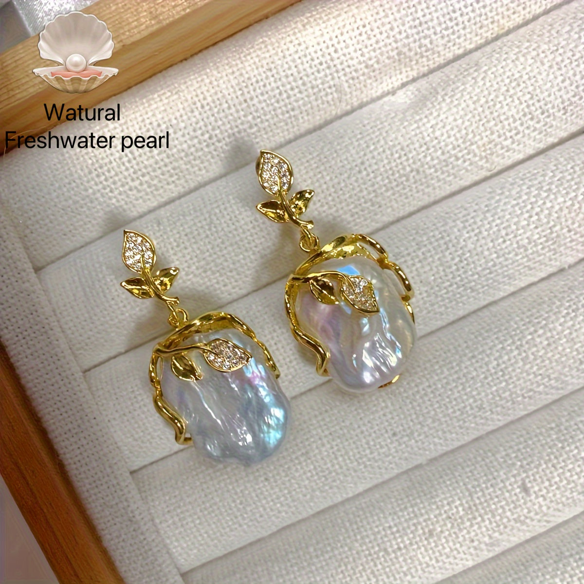 Elegant and luxurious French-inspired freshwater pearl earrings with gold-plated silver leaf accents, perfect for fashion-forward women with a taste for retro style and natural beauty.