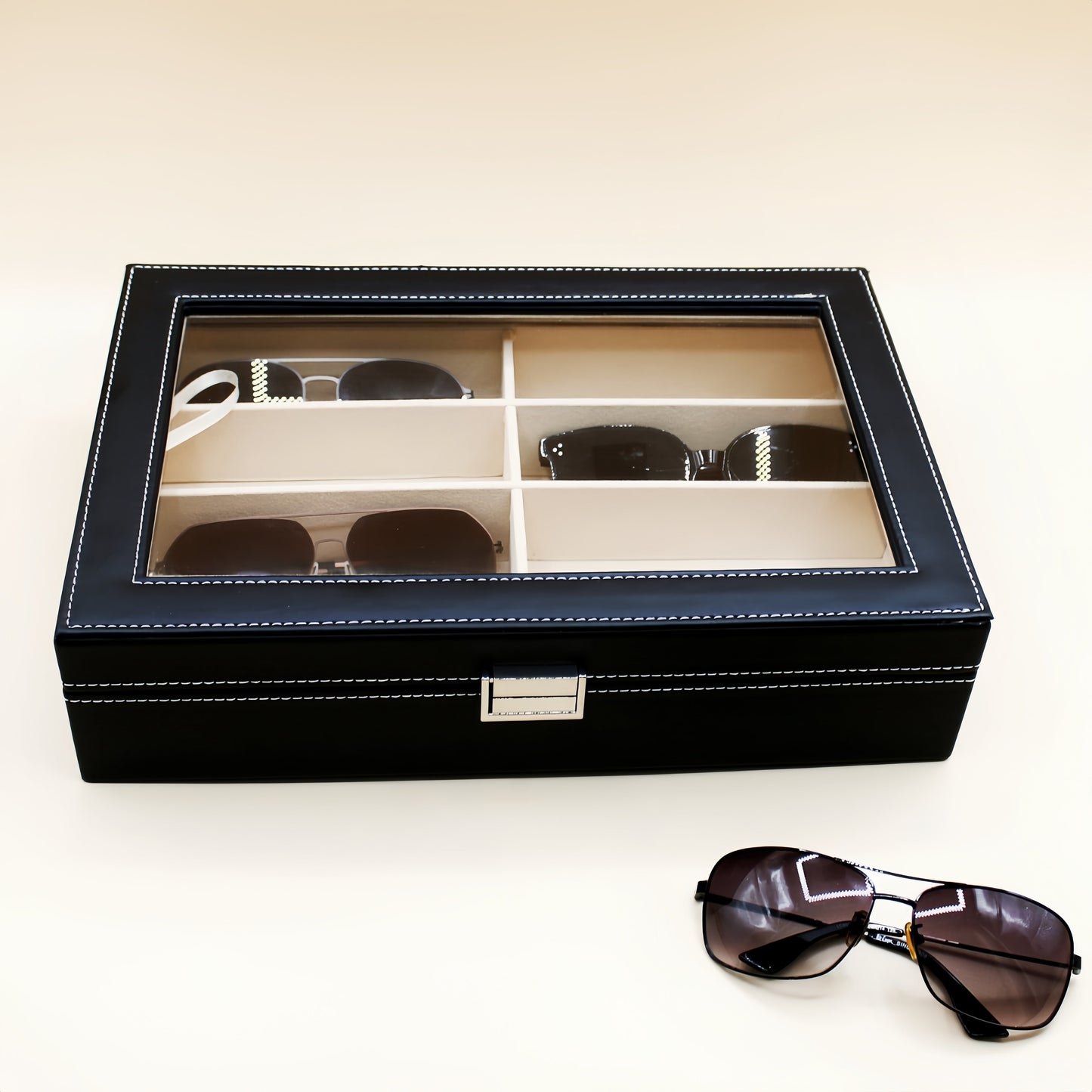 Organize your sunglasses in style with this retro PU leather eyewear display case featuring 8 slots and stitch detail. The glass lid allows you to easily see and access your sunglasses while keeping them protected. Store your glasses in this sleek and