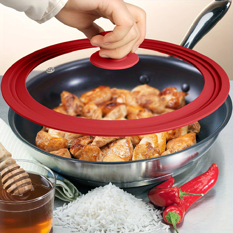 Multi-functional red silicone-rimmed glass lid designed for pots and skillets from 20.32cm to 27.94cm in diameter - can be safely cleaned in the dishwasher, features a non-slip knob, and is heat resistant.