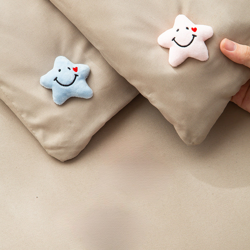 Set of 4 adorable star-shaped quilt and bed skirt fixators made of practical nylon. These anti-run corner holders feature smiling faces and hearts in blue, ensuring secure bedding with their soft plush design.