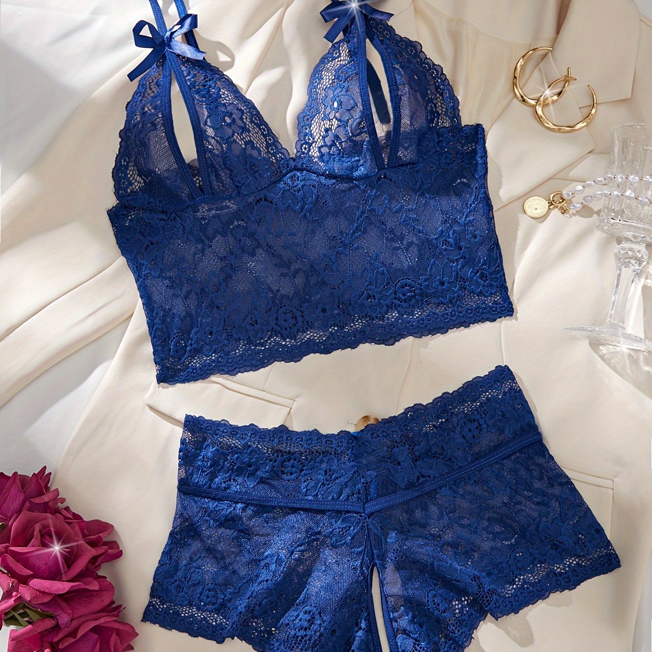 Floral lace lingerie set with bow bra and crotchless panties for a seductive look.