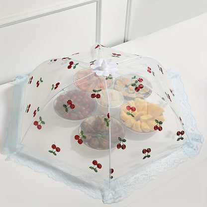 Foldable food cover with cherry design, lace trim and bow, protects against mosquitoes and dust, ideal for kitchen and dining.