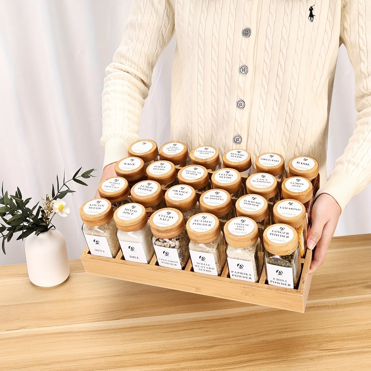 The spice rack includes either 12 or 24 jars with bamboo lids, as well as a bamboo drawer organizer complete with attached waterproof adhesive labels specifically designed for English herbs, spices, and condiments for convenient and easy access.