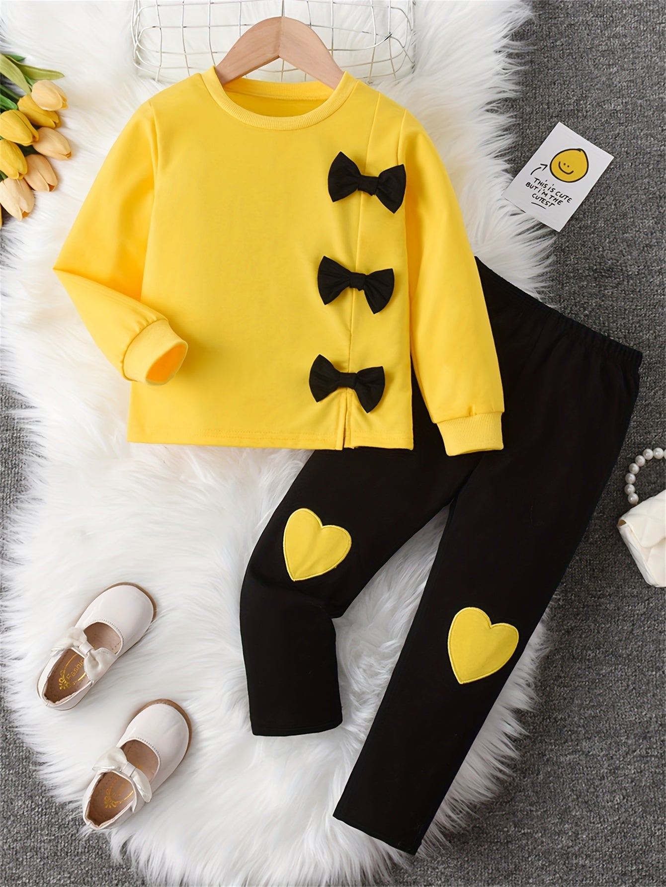 Girls' sweatshirt with bow decoration, long sleeves, and matching pants with love embroidery, ideal for outdoor activities.