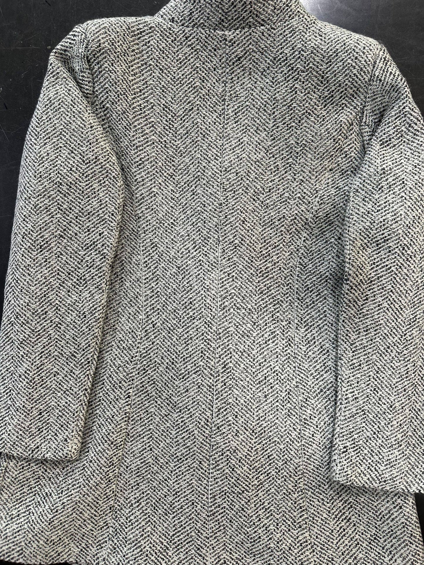 Women's chic, mid-length tweed coat with slim fit, button front, long sleeves, and side pockets for fall/winter.