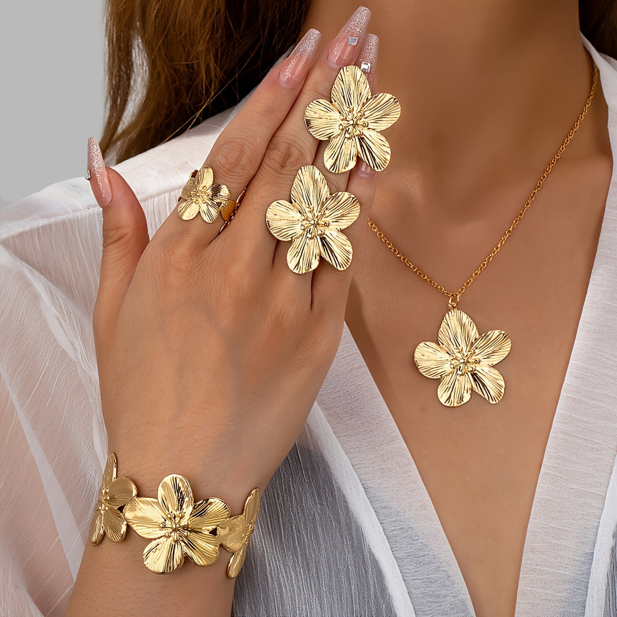 Set of 5 stylish and beautiful floral jewelry pieces including earrings, rings, bracelets, and necklaces.