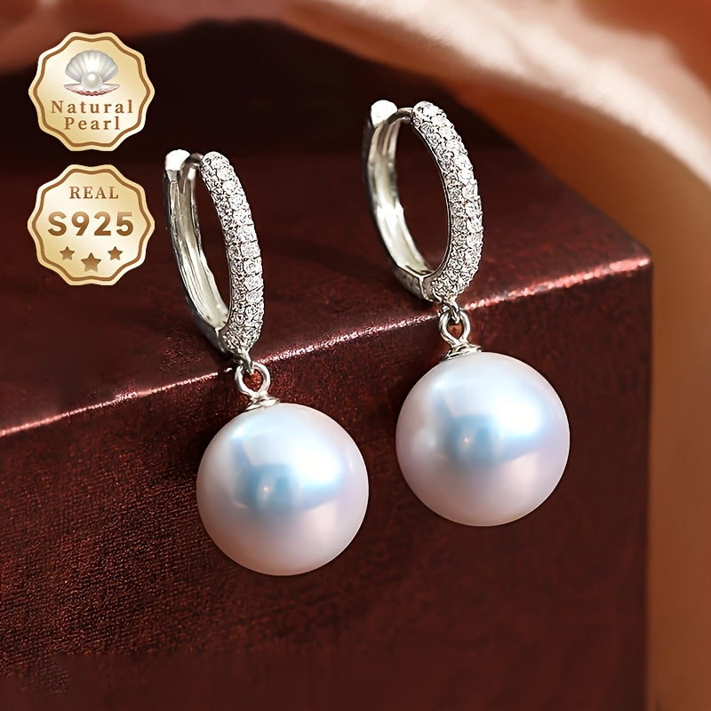 Get ready to dazzle with the luxurious elegance of these Daimi Hoop Earrings, made with 925 Sterling Silver and adorned with a natural Freshwater Pearl, the perfect June Birthstone gift for any occasion