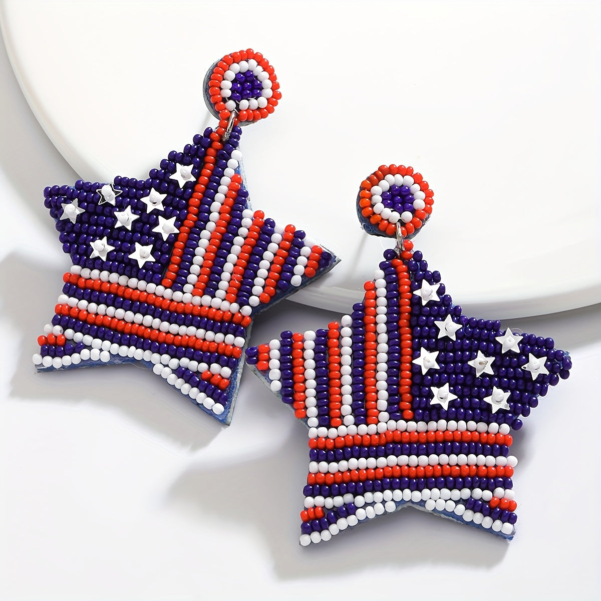 Handcrafted American flag beaded earrings with a boho chic vibe, featuring celestial symbols and a cute style. Made with stainless steel posts, these earrings are perfect for daily wear or festivals all year round. Feather-free design.