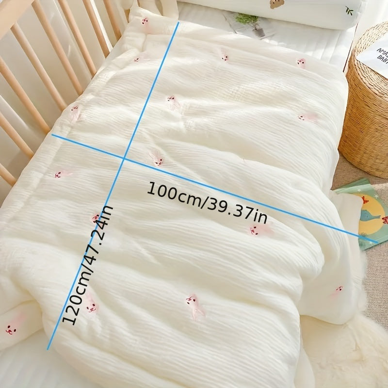 Soft cream-colored quilt with embroidered bear and rabbit, perfect for kids all year round. Made from durable knit fabric for naps and home use.