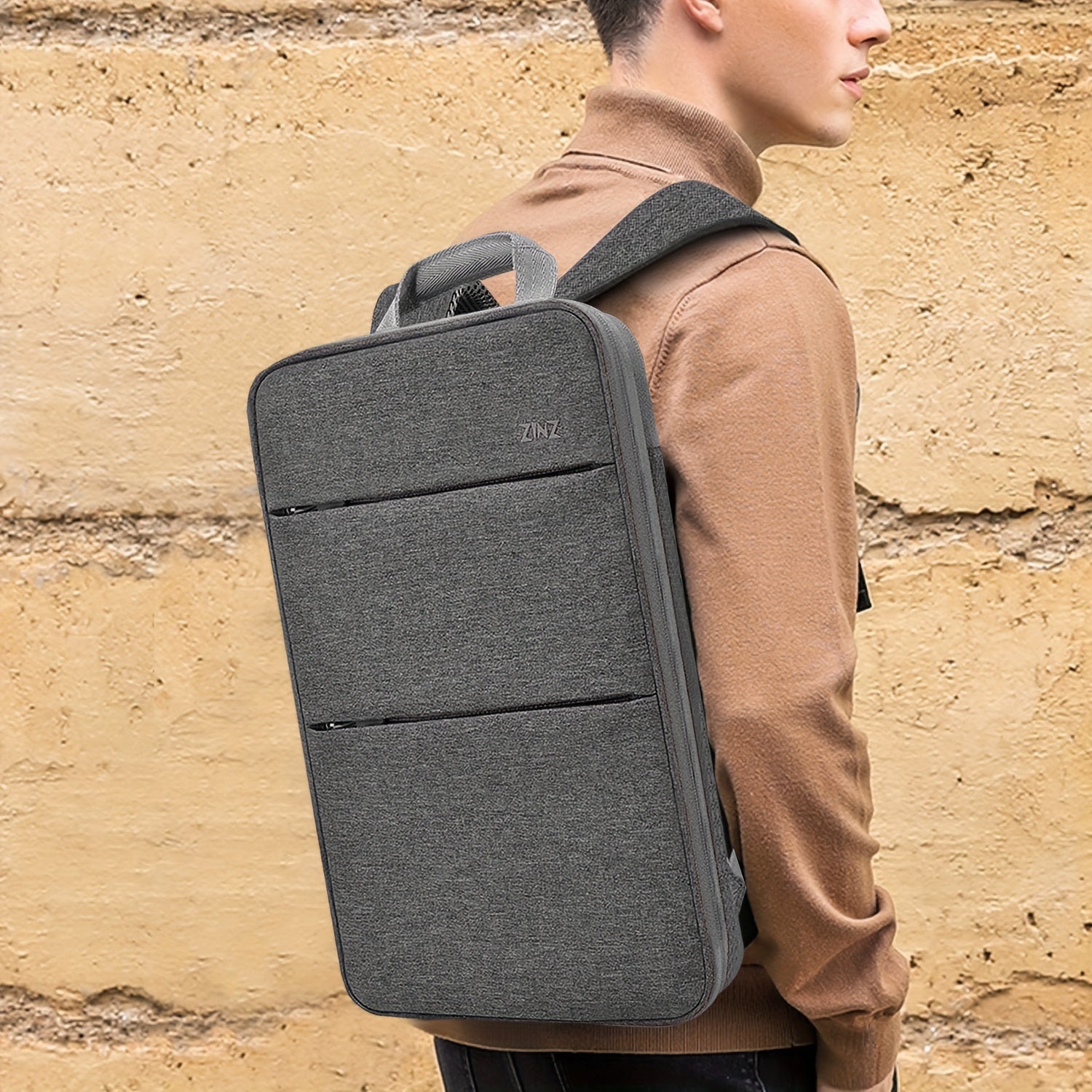 Ultra-slim laptop backpack for 35.56-40.64cm laptops, spill-resistant with durable polyester material.