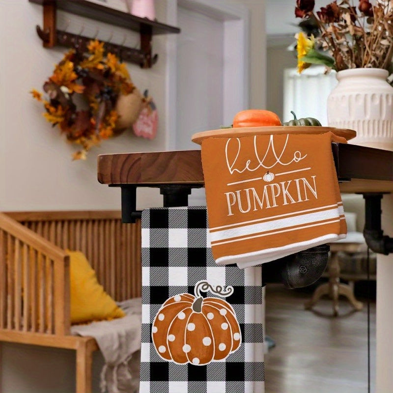 Set of 2 kitchen towels measuring 45.72*66.04 cm featuring autumn pumpkin elements for home decor. These reusable towels are perfect for parties, holiday decorations, and make a great gift. The design includes a black buffalo plaid polka dot pumpkin