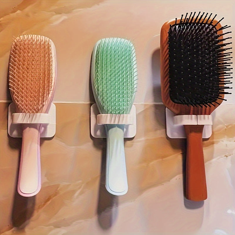 Wall-mounted comb holder for bathroom storage, featuring a punch-free design and multifunctional storage hook.