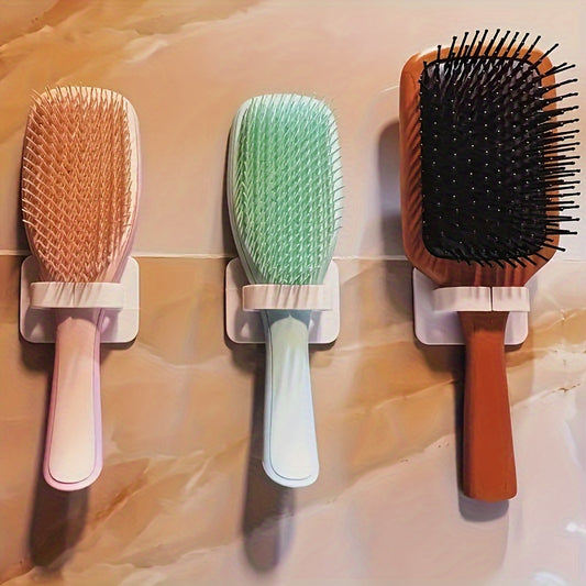 Wall-mounted comb holder for bathroom storage, featuring a punch-free design and multifunctional storage hook.