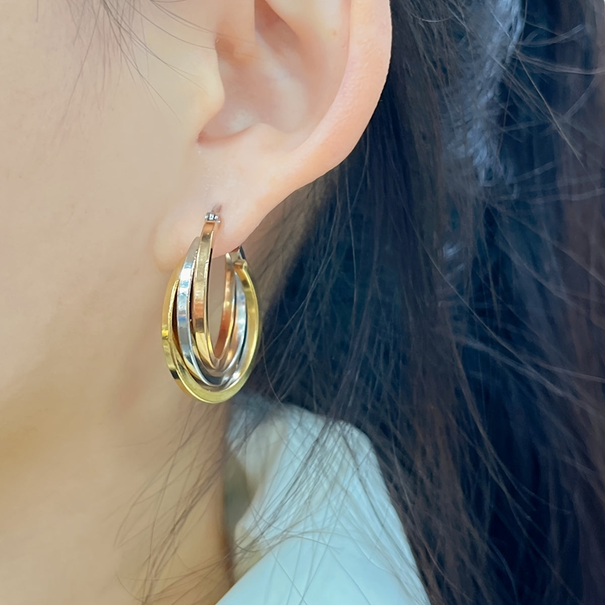 Multi-color twisted triple layered hoop earrings with a two-tone leverback design, perfect for adding a pop of color and style to any party, club, or vacation outfit. Give the gift of stunning jewelry to a loved one.